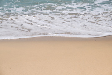 Calm Waves Washing Over a Beach on a Sunny Day