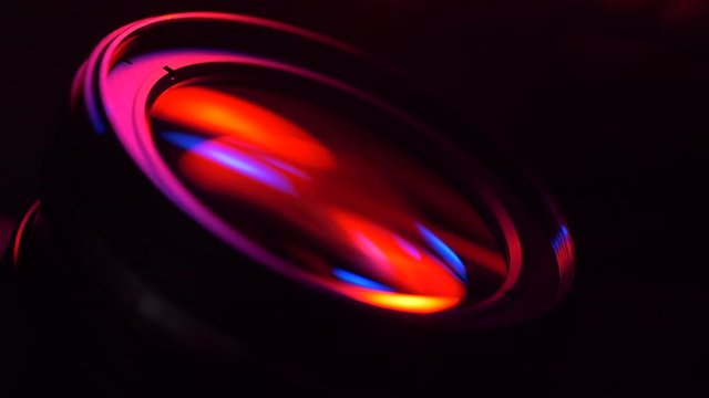 Stylized cinematic red and blue lighting swipe of camera lens glass