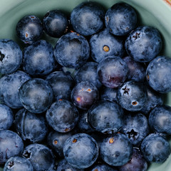 Fresh blueberry in bowl. Top view. Concept of healthy and dieting eating
