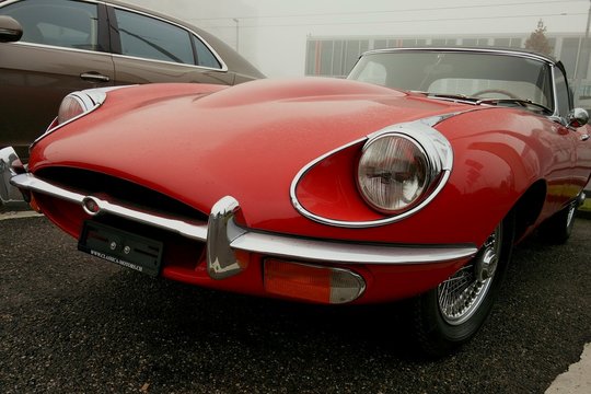 Red Vintage Convertible Car In Parking Lot