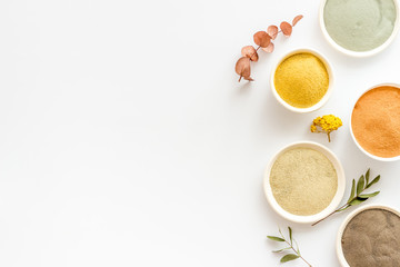 cosmetic clay - Yellow, red, white, blue and black - on white background top-down space for text