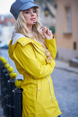 Spring girl walking in a yellow coat