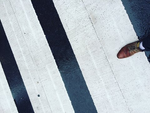 Low Section Of Man Walking On Street