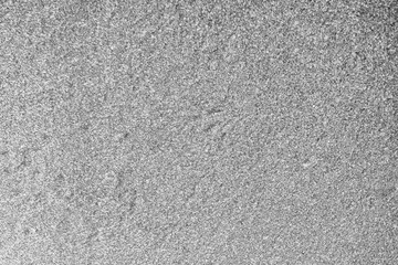 gray black and white grain background of wall , monochrome surface texture , asphalt backdrop close up