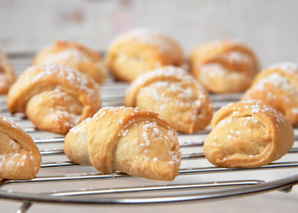 Homemade mini croissants on a cooling rack. Confectionery menu concept