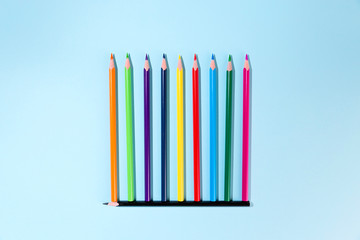 A group of colored pencils as a group of people keeping a distance. Virus design concept.