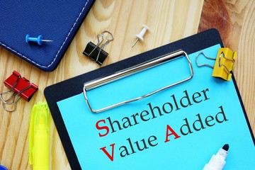 The caption in the picture is Shareholder Value Added SVA. Notebook sheet, table, pens.