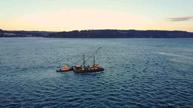 Tugboat Sailing On The Puget Sound During The Beautiful Sunset On The Pacific Northwest, Washington, USA.-aerial shot