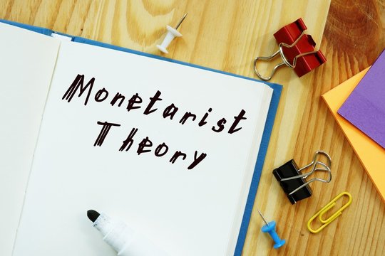 The caption in the picture is Monetarist Theory. Notebook sheet, table, pens.