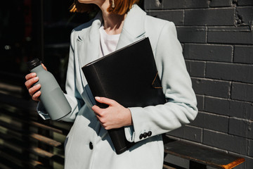 Chic woman holding a bottle