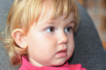 Close up portrait of a cute child watching tv