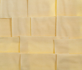 Fototapeta premium Sheets for lasagna isolated on white background. Pile of dry uncooked Italian pasta
