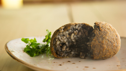 Black sepia arancini from italy