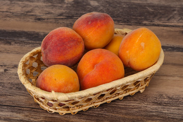 Peach heap in the wooden basket
