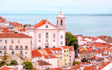 Fototapeta premium Lisbon. Portugal. Beautiful view of the city, a tourist route along the famous Alfama district. Miradouro de Santa Luzia viewpoint with the Alfama old town and Saint Stephen Church in background.