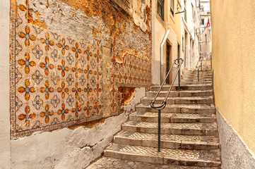  Lisbon, Portugal. Old streets in Alfama.Traditional old tiles on the walls - azulejo.
