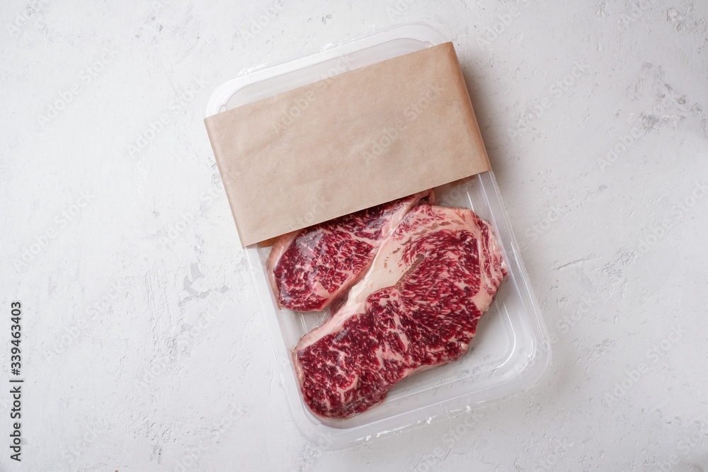 Wall mural raw beef striploin steak in vacuum packaging, mockup meat for the logo design idea