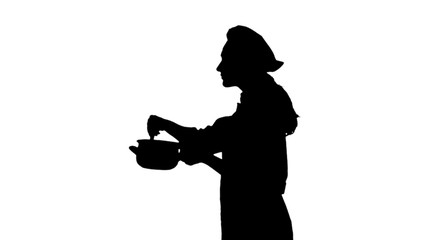 Portrait of black silhouette of a cook woman in uniform trying dish.