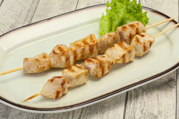 Grilled pork skewer served salad
