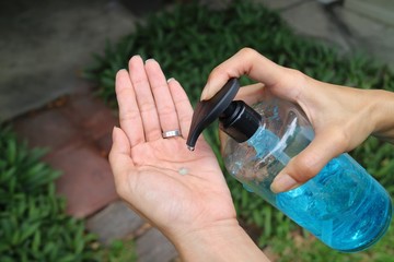 People using alcohol antiseptic gel when go outside home, prevent against infection of Corona virus or Covid-19 outbreak. Healthcare and people concept.