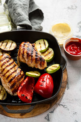 Grilled chicken and vegetables on iron pan