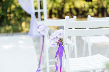 Fototapeta na wymiar wedding decor at a visiting ceremony, a wedding arch of white color with violet flowers