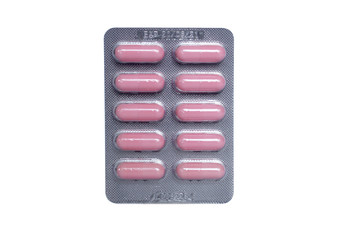 pink capsule in blister packs isolated on white background.