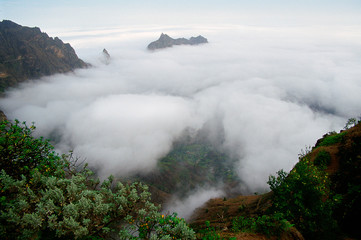 Mountainous island above the clouds