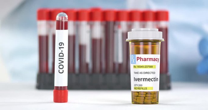 Lab tube with COVID-19 test and pharmacy bottle with ivermectin generic pills on the table