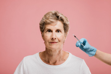 Old woman getting injected