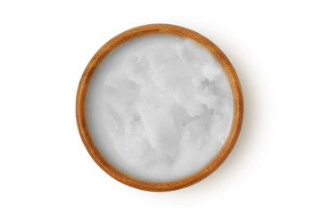 Coconut oil in wooden bowl on white background