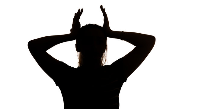 silhouette of a young woman with hands up in stress on a white isolated background, concept female emotions, fear and depression - Powered by Adobe