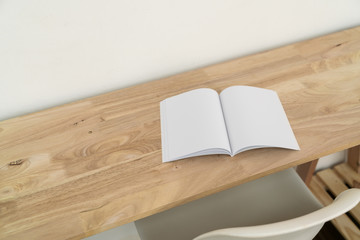Blank catalog, magazines, book on wood background.