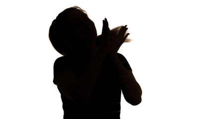 silhouette of a cute clapping hands girl, young happy woman with long hair on a white isolated background