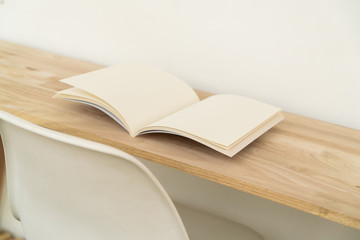 Blank catalog, magazines, book on wood background.