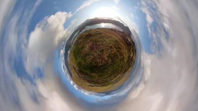 Little planet time-lapse with fall colors and sun reflected in ocean, 4K