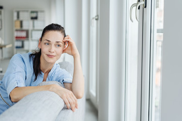Young woman relaxing looking out of a window