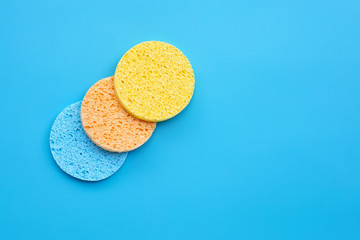 Sponge for  face make-up cleaning on blue background.