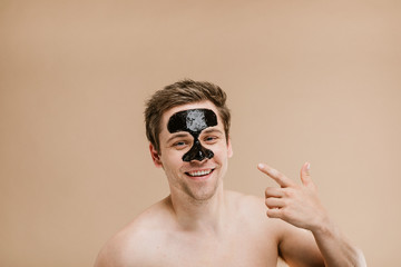 Portrait of a man wearing black pore mask
