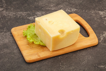 Emmental cheese over wooden board