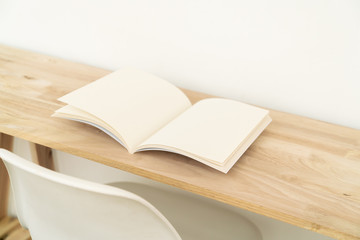 Blank catalog, magazines, book on wood background.