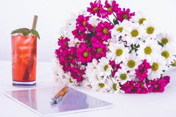 cold cocktail and a large bouquet of red and white chrysanthemums