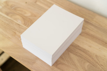 Blank catalog, magazines, book on wood background.