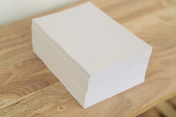 Blank catalog, magazines, book on wood background.