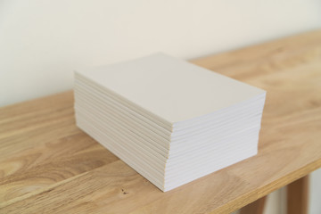 Blank catalog, magazines, book on wood background.