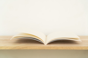 Blank catalog, magazines, book on wood background.