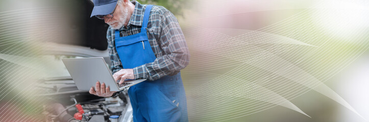 Mechanic using laptop for checking car engine; panoramic banner