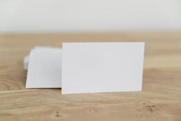 Blank business cards on wooden surface.