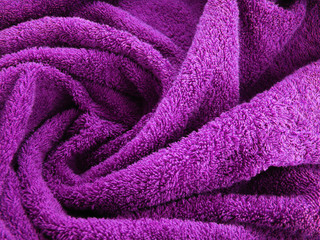 Fototapeta na wymiar Purple swirl towel made of natural cotton