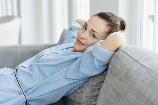 Trendy relaxed young woman unwinding at home